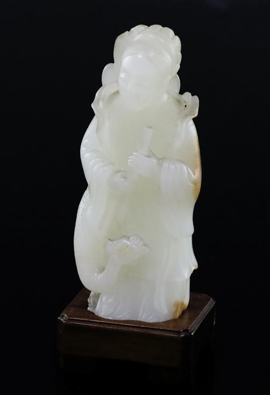 A fine Chinese white and russet jade group of Xi Wangmu and a phoenix, 19th/20th century, 9.5cm high, wood stand